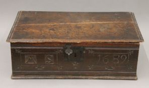 An 18th century carved oak Bible box. 61 cm wide.