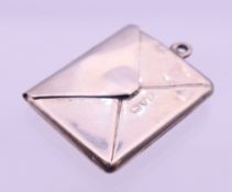 A silver envelope form stamp holder pendant. 2.75 x 2.4 cm.