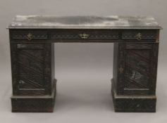 A Victorian carved oak desk. 126 cm wide.