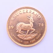 A 1974 gold Krugerrand 1 oz coin.