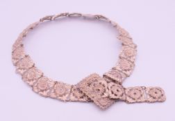 An unmarked white metal chatelaine belt. 75 cm long overall (72 cm long belt size), 2.5 cm high.