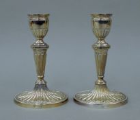 A pair of silver candlesticks. 16 cm high.