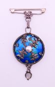 An unmarked silver and enamel brooch/pendant. 9.5 cm high overall.