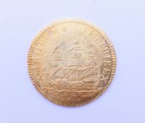 A Soli Deo Gloria gold coin. 2 cm diameter. 2.3 grammes.