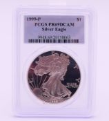 A silver proof Liberty dollar 1999-P-slabbed.