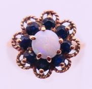 A 9 ct gold cluster ring. Ring size L. 3 grammes total weight.