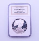 A 1992 silver Ultra Cameo proof 1 oz one dollar coin (NGC PF69), slabbed.