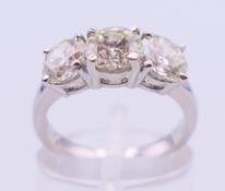 A platinum three-stone diamond ring (colour approximately J, clarity approximately VS1),