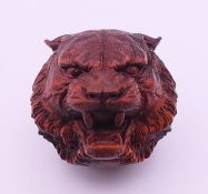 A tiger's head carving. 3 cm high.
