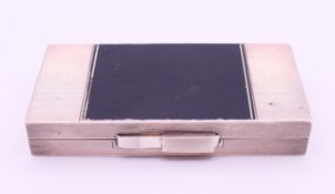 An Art Deco style silver and black enamel vanity compact with cigarette case,
