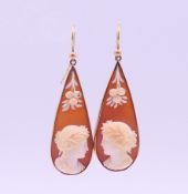 A pair of Victorian unmarked gold and cameo earrings. 4 cm high.