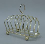 A large silver toast rack. 18 cm long. 354.7 grammes.
