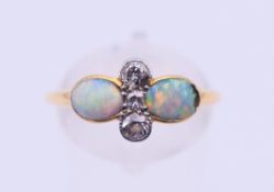 An 18 ct gold, opal and diamond ring. Ring size P/Q. 1.9 grammes total weight.