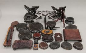 A collection of various wooden stands, mostly Chinese. The largest 14 cm diameter.