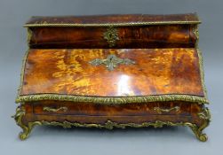 A 19th century Continental ormolu and tortoiseshell ladies' table bureau. 63.5 cm wide x 35 cm high.