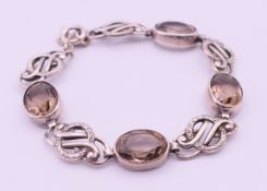 A Scottish silver and topaz bracelet. Approximately 18 cm long, 1.2 cm high.