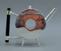 A Christopher Dresser-style teapot. 14 cm high.