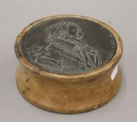 A 19th century Commemorative plaque depicting possibly Henry IV of France, on a wooden base.