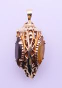 A 9 ct gold three-sided pendant, each side set with a with a different stone. 7.