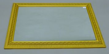 A modern gilt-framed mirror. 74.5 x 107 cm.
