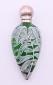 A Victorian unmarked white metal mounted green cameo glass scent bottle with stopper. 11 cm high.