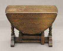 An oak drop leaf coffee table. 46 cm high.