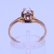 An unmarked 9 ct gold diamond solitaire ring. Ring size P/Q. 2 grammes total weight.