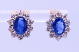 A pair of 18 ct gold, sapphire and diamond earrings with 18 ct gold retainer clips. 1.2 cm high.