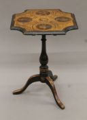 A Victorian pen work tilt top tripod table. 49 cm wide.