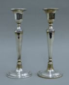 A pair of silver candlesticks. 21.5 cm high.