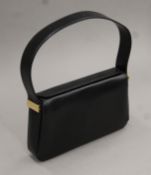 A Givenchy leather handbag in dust bag. 25 cm wide.
