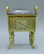 A 19th century Chinese bronze censer with carved wooden cover. 16 cm wide.