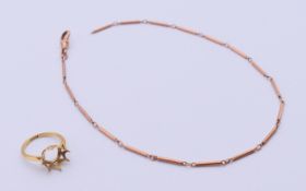 A 9 ct rose gold Albert chain (6.2 grammes) and a 18 ct gold ring shank (2.3 grammes).
