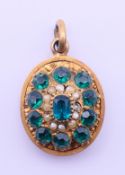 An unmarked, green stone and seed pearl locket pendant. 1.5 cm high excluding suspension loop.