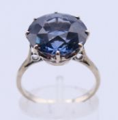 A white metal solitaire paste dress ring. Ring size N/O.