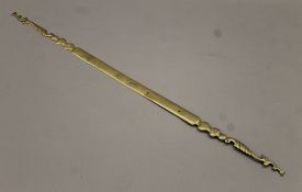 An 18th century brass door latch front. 122 cm long.