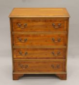 A modern yew wood veneered chest of drawers. 76 cm wide.