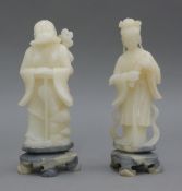 A pair of Chinese soapstone figures. The larger 22 cm high.