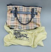 A Burberry handbag in original dust bag. 38 cm wide.
