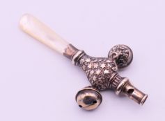 A silver and mother-of-pearl baby rattle and whistle. 8.7 cm long.