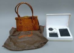 A Gen Rigo leather handbag in original dust bag and a boxed Fiorelli purse keyring and notepad set.