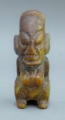 A tribal hardstone carving of a seated woman. 11.5 cm high.