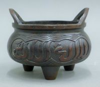 A Chinese bronze censer with Arabic script. 13 cm diameter.