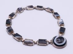 A silver and cats eye agate link necklace.