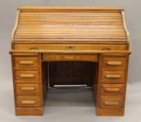 An early 20th century oak tambour-fronted roll top desk. 126 cm wide.