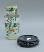 A late 19th century Japanese crackleware vase and a Chinese carved wooden stand.