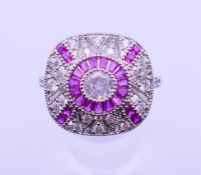 An Art Deco style white metal dress ring. Ring size R/S.