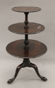 A 19th century mahogany three-tier circular dumb waiter. 105 cm high.