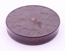 A 19th century carved wooden snuff box. 8 cm diameter.