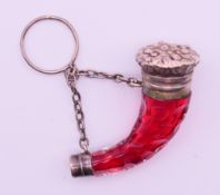 A Victorian white metal mounted cranberry glass cornucopia form scent bottle with stopper,